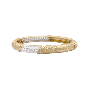 A Van Cleef & Arpels bangle in yellow gold, platinum and diamonds.